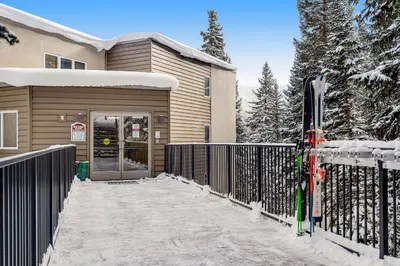 a house with a gate and skis in the snow at Iron Horse Resort 3063 in Winter Park