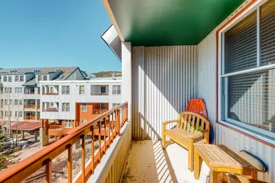 a balcony with a bench and a view of a city at Silvermill Lodge 8285 in Keystone