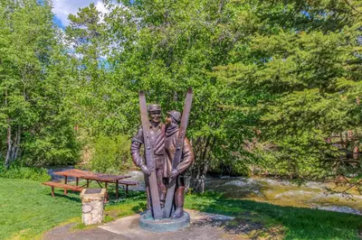 a statue of a man with skis on his shoulders at Silvermill Lodge 8285 in Keystone