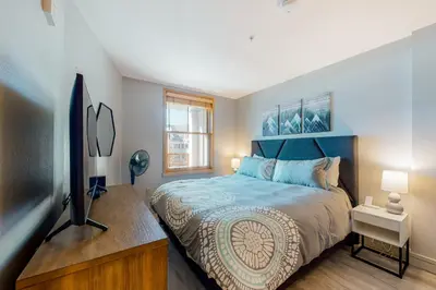 a bedroom with a large bed and a television at Silvermill Lodge 8285 in Keystone