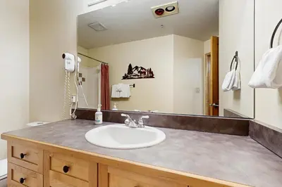 a bathroom with a sink and a mirror at Silvermill Lodge 8295 in Keystone