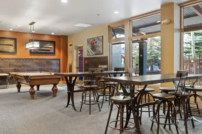 a room with a ping pong table and pool tables at Silvermill Lodge 8295 in Keystone