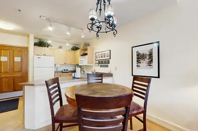 a kitchen and dining room with a table and chairs at Silvermill Lodge 8295 in Keystone