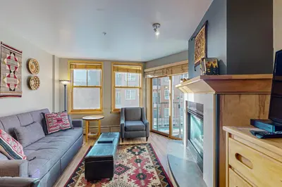 a living room with a couch and a fireplace at Silvermill Lodge 8202 in Keystone