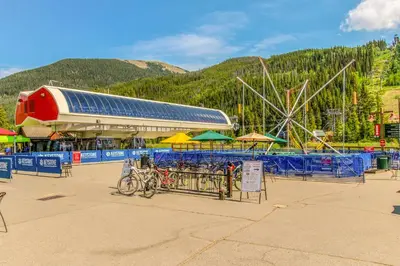 an amusement park with a ferris wheel and tables with umbrellas at Silvermill Lodge 8202 in Keystone