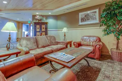 a living room with leather furniture and a table at Silvermill Lodge 8202 in Keystone