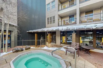 a hot tub in a courtyard in front of a building at Silvermill Lodge 8202 in Keystone
