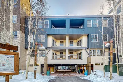 an apartment building in the winter with snow on the ground at Silvermill Lodge 8202 in Keystone