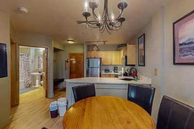 a kitchen with a wooden table and a dining room at Silvermill Lodge 8202 in Keystone