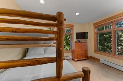 a bedroom with two bunk beds and a tv at Lone Eagle 3016 in Keystone