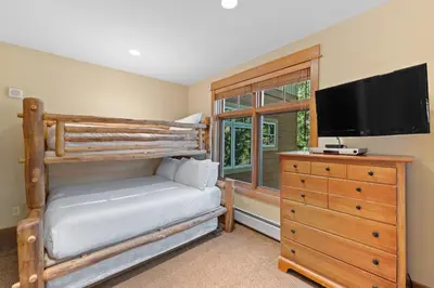 a bedroom with a bunk bed and a flat screen tv at Lone Eagle 3016 in Keystone