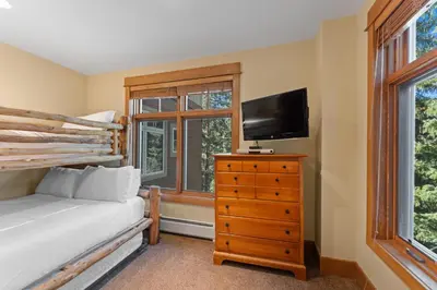 a bedroom with a bed and a flat screen tv at Lone Eagle 3016 in Keystone