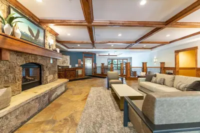 a living room with a stone fireplace and couches at Lone Eagle 3016 in Keystone