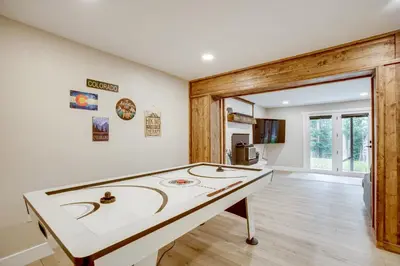 a ping pong table in the middle of a room at Hot Tub and Game Room Peaceful Retreat in Evergreen in Evergreen