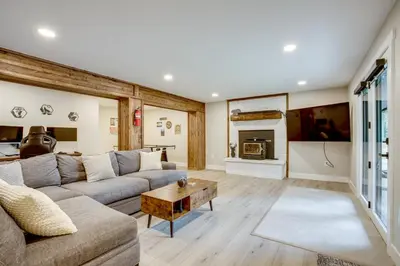 a living room with a couch and a fireplace at Hot Tub and Game Room Peaceful Retreat in Evergreen in Evergreen