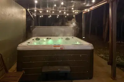 a jacuzzi tub in a room with lights at Hot Tub and Game Room Peaceful Retreat in Evergreen in Evergreen