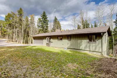 a green house in the middle of a yard at Hot Tub and Game Room Peaceful Retreat in Evergreen in Evergreen