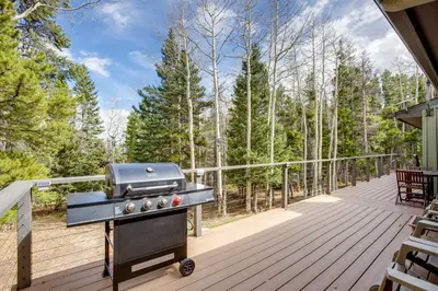 a grill on the deck of a house at Hot Tub and Game Room Peaceful Retreat in Evergreen in Evergreen