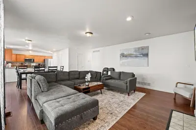 a living room with a couch and a table at Spacious SIX Bedroom, Great Location in Longmont