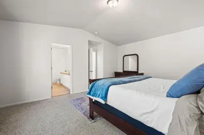 a bedroom with a large bed and a mirror at Spacious SIX Bedroom, Great Location in Longmont
