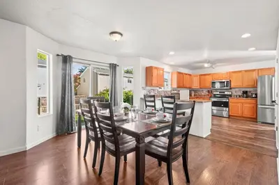 a kitchen and dining room with a table and chairs at Spacious SIX Bedroom, Great Location in Longmont