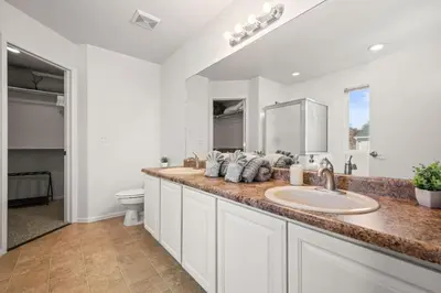 a white bathroom with a sink and a toilet at Spacious SIX Bedroom, Great Location in Longmont