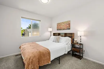 a bedroom with a large bed and a window at Spacious SIX Bedroom, Great Location in Longmont