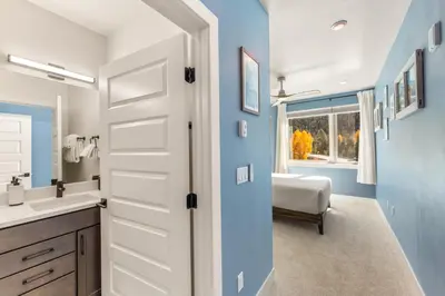 a bathroom with a white door leading to a bedroom at Brightwood 107 in Keystone
