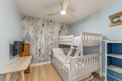 a small room with a bunk bed and a desk at Brightwood 107 in Keystone