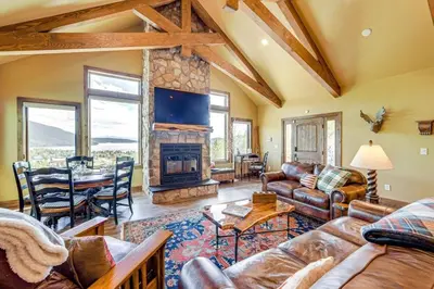 a living room with a couch and a fireplace at New Mountain Home, Amazing Unobstructed Lake & Mountain Views, Hot Tub, Close to Town! in Grand Lake