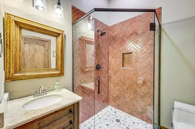 a bathroom with a shower and a sink at New Mountain Home, Amazing Unobstructed Lake & Mountain Views, Hot Tub, Close to Town! in Grand Lake