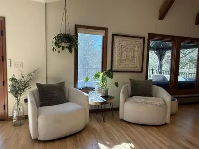 a living room with two chairs and a table at RollinsVilla home in Rollinsville