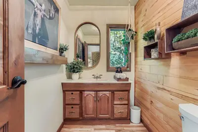 a bathroom with a sink and a mirror at RollinsVilla home in Rollinsville