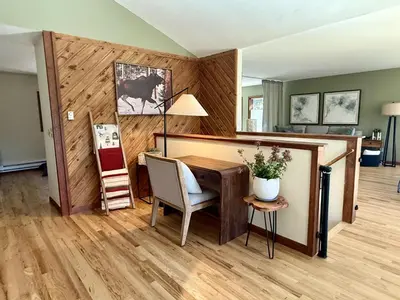 a room with a desk and a table with a chair at RollinsVilla home in Rollinsville