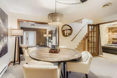 a dining room with a table and chairs at RollinsVilla home in Rollinsville