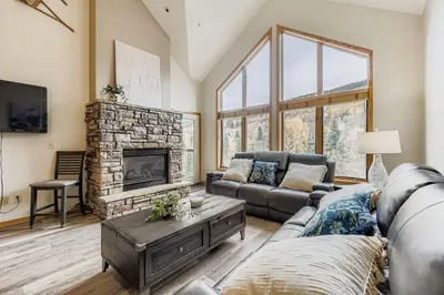a living room with a couch and a fireplace at 5094 Gateway condo in Keystone