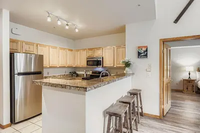 a kitchen with wooden cabinets and a counter top at 5094 Gateway condo in Keystone