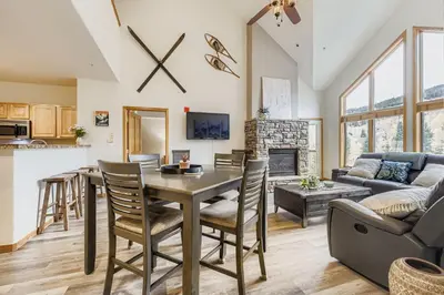 a kitchen and living room with a table and chairs at 5094 Gateway condo in Keystone