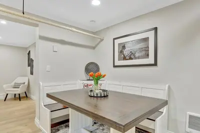 a dining room with a table and a vase of flowers at Modern Comfort in Historic Denver in Denver