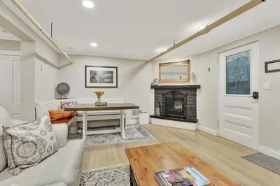 a living room with a couch and a fireplace at Modern Comfort in Historic Denver in Denver