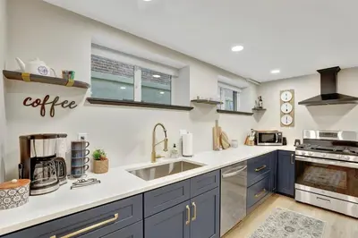 a kitchen with blue cabinets and a sink at Modern Comfort in Historic Denver in Denver