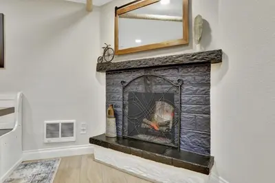 a fireplace with a mirror on top of it at Modern Comfort in Historic Denver in Denver