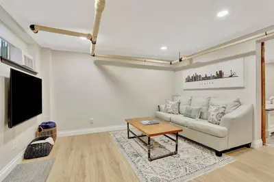 a living room with a couch and a table at Modern Comfort in Historic Denver in Denver
