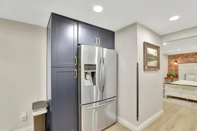a kitchen with a stainless steel refrigerator in a room at Modern Comfort in Historic Denver in Denver