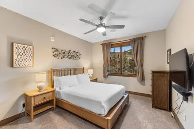 a bedroom with a bed and a ceiling fan at Seasons at Keystone 1893 in Keystone