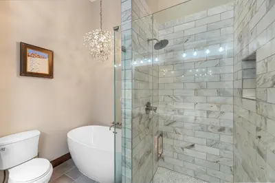 a bathroom with a toilet and a glass shower at Seasons at Keystone 1893 in Keystone