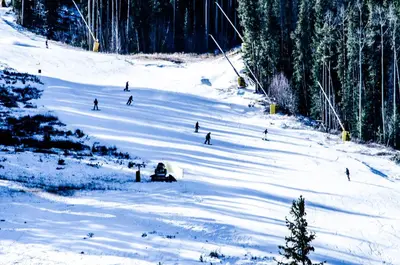 a group of people skiing down a snow covered slope at Seasons at Keystone 1893 in Keystone