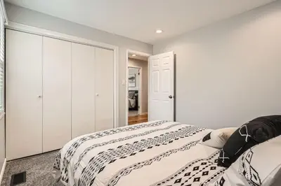 a white bedroom with a bed and a closet at Littleton DTC updated GEM with Hot Tub! in Centennial