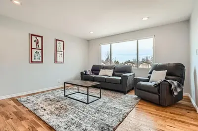 a living room with two couches and a table at Littleton DTC updated GEM with Hot Tub! in Centennial