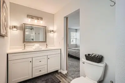 a white bathroom with a sink and a toilet at Littleton DTC updated GEM with Hot Tub! in Centennial